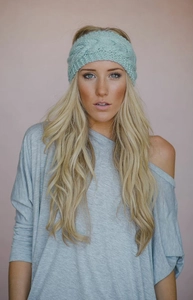 Detail view of mint green chunky knit headband featuring a stylish twist cable pattern