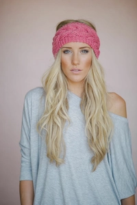 Detail of pink cable knit headband showing the thick woolen texture and ear warmer design