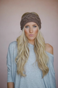 Detailed knit texture of brown ear-warming headband with thick cable pattern
