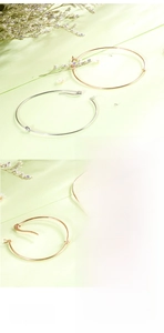 Detailed close-up of rose gold and silver knotted stainless steel minimalist bangles