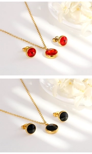 Detail of gold jewelry set featuring red and black zircon necklaces and earrings