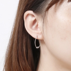 Minimalist silver twist hoop earrings with textured rope design for elegant women
