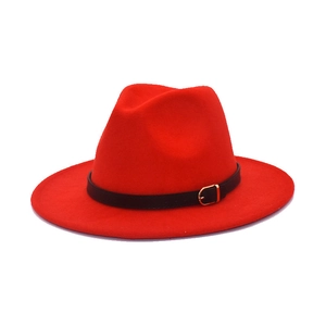 Detail of red wool fedora hat featuring black decorative belt and gold buckle