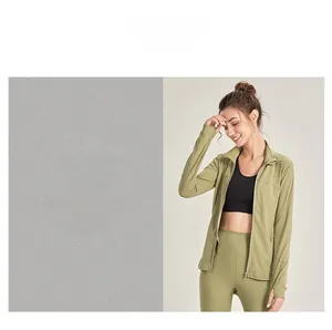 Detail of green sports jacket featuring thumbhole cuffs and breathable laser-cut holes