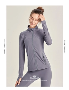 Detail of light grey athletic jacket showing thumb hole cuffs and slim fit design