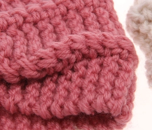 Close-up of pink chunky knit headband featuring bohemian textured wavy stitch detail