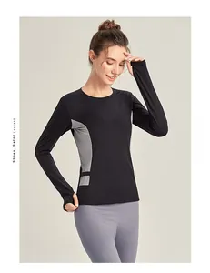 Détail du haut de sport à manches longues avec empiècements gris et passe-pouces