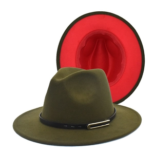 Detailed view of olive green fedora hat featuring a red brim underside and gold buckle