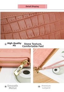 Detail of pink stone pattern wallet featuring smooth metal zipper and premium wrist strap