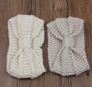 Detailed knit texture and central twist of beige and cream winter ear warmers