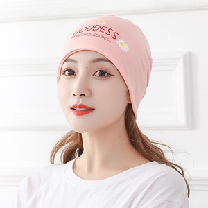 Pink knit confinement hat with floral daisy pattern and goddess text for women