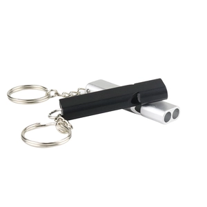 Macro view showing double-tube aluminum alloy survival whistles in black and silver finishes
