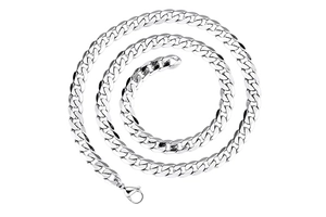Macro shot of 7mm silver diamond-cut curb chain coiled on a white background