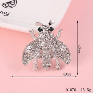 Macro detail of silver bee brooch with dimensions 42mm x 40mm and micro-inlaid crystals
