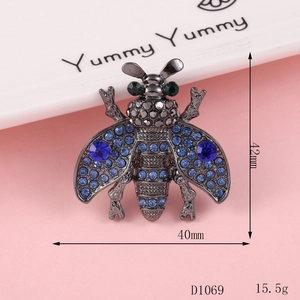 Detail of bee brooch with dark blue rhinestones and size specs 42mm by 40mm