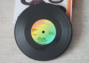 Detailed top view of a black vinyl record coaster with retro Spectrum Records label