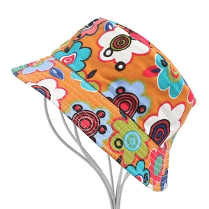 Detailed close-up of colorful floral print pattern on orange cotton bucket hat