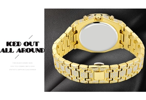 Detail of iced out gold watch case back and diamond-studded strap on dark fabric
