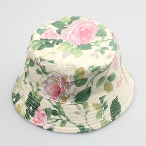 Detail of floral bucket hat with pink rose patterns on beige canvas fabric