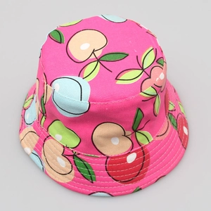 Detail of rose red sun hat featuring colorful fruit patterns on durable canvas fabric