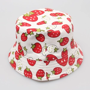Close-up of white cotton sun hat with vibrant red strawberry pattern for children