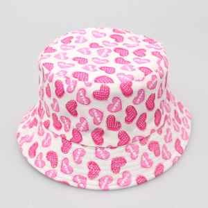 Close-up of pink heart pattern and 'love you' print on a white canvas bucket hat