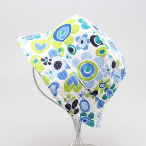 Detail view of floral print sun hat for kids featuring blue and green botanical patterns