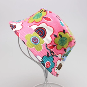 Detail showing pink floral canvas bucket hat with green and blue abstract patterns