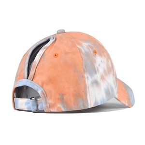 Detail of adjustable metal buckle and ponytail hole on tie-dye cotton sun visor cap