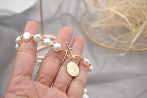 Baroque freshwater pearl bracelet with 18K gold OT clasp and Elizabeth coin charm