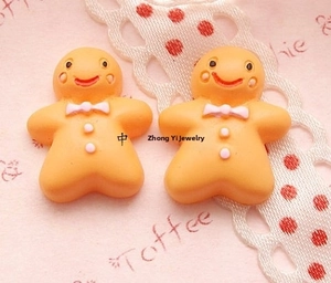 Pair of orange gingerbread man resin charms for DIY crafts and hair accessories