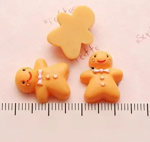 Detailed scale view of resin gingerbread man charms for DIY crafts and phone case decor
