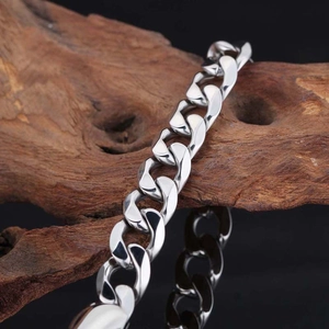 Bracelet gourmette poli en acier titane argenté pour couples sur socle en bois