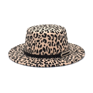 Detail of leopard print boater hat featuring a black ribbon band and golden metal buckle