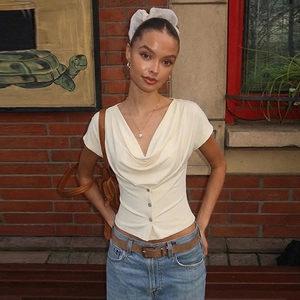 Detailed view of beige cowl neck knit top featuring button front and slim fit design