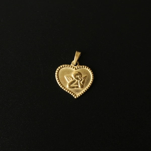 Detailed macro view of 18K gold-plated heart pendant with embossed angel and beaded edge