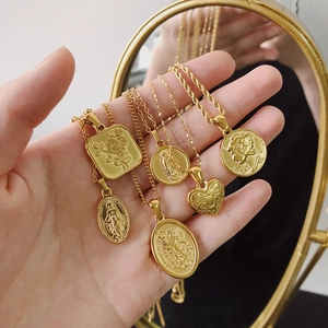 Set of 6 vintage 18K gold plated titanium necklaces with embossed portrait and heart pendants