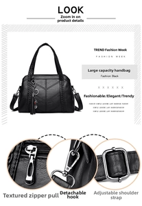 Detail of leather tote featuring metallic tassel charm and adjustable hardware components