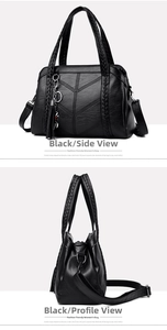 Detail of black pebbled faux leather tote with V-shaped stitching and tassel accent