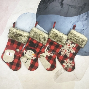 Set of 4 buffalo plaid Christmas stockings with plush faux fur cuff and reindeer icons