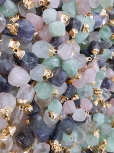 Detailed view of assorted natural raw stone pendants with elegant gold metal clasps