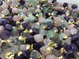 Detailed collection of raw natural stone pendants with faceted edges and gold metal caps
