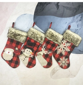 Detailed embroidery of Santa and Reindeer on red buffalo plaid Christmas stockings
