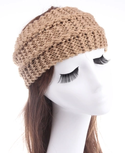 Detail of earthy brown chunky knit headband showing wavy texture and thick wool yarn material