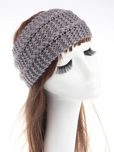 Detail of grey knitted winter headband with bohemian cable knit texture on a model