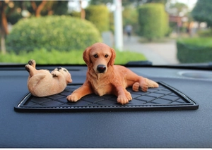 Detailed resin Golden Retriever dog figurines on car dashboard with realistic fur texture