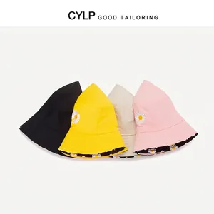 Double-sided sun hat with daisy embroidery in four colors on a plain white background