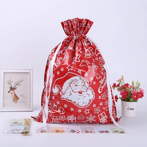 Red Christmas drawstring gift bag with Santa Claus pattern and matching tags