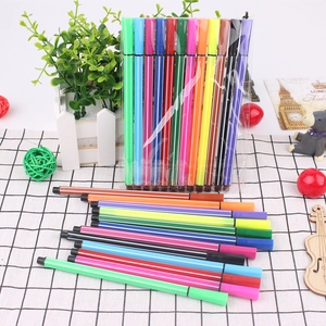 Detail of hexagonal washable watercolor pens in various colors on a checkered cloth background