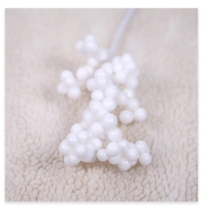 Detail of white artificial berry stems for Christmas DIY crafts and festive decor